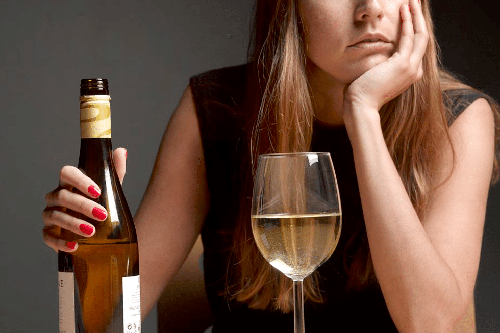 woman holding bottle of wine