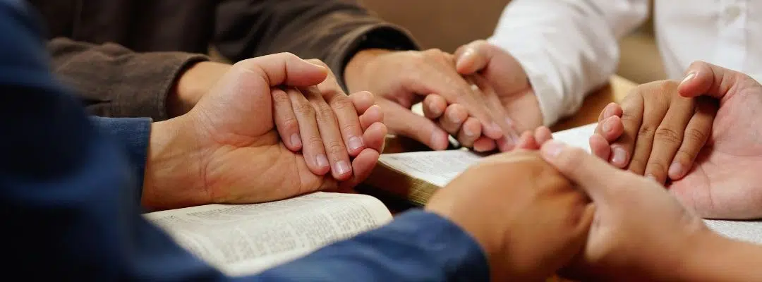 People in recovery holding hands in unity and shared healing