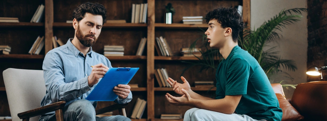 Counselor offering compassionate therapy to adult child of an alcoholic