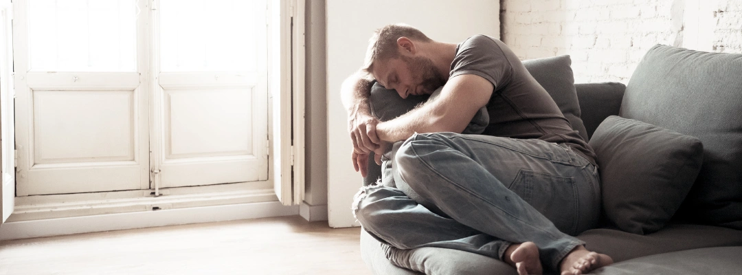 Image of a man looking distressed, showing signs of psychological effects like depression or anxiety