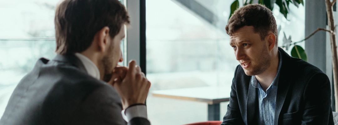 Image of a person having a sincere conversation with a friend or coworker, conveying honesty, apology, and emotional healing