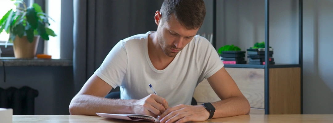 Image of a person organizing documents and medication lists in preparation for a court-ordered drug or alcohol evaluation