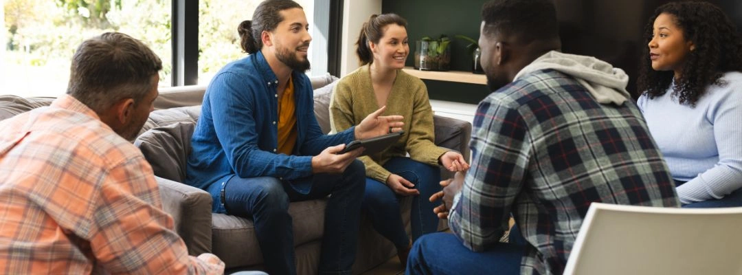 Image of men and women gathered at a Co-Anon meeting - What is Co-Anon - Purpose healing Center