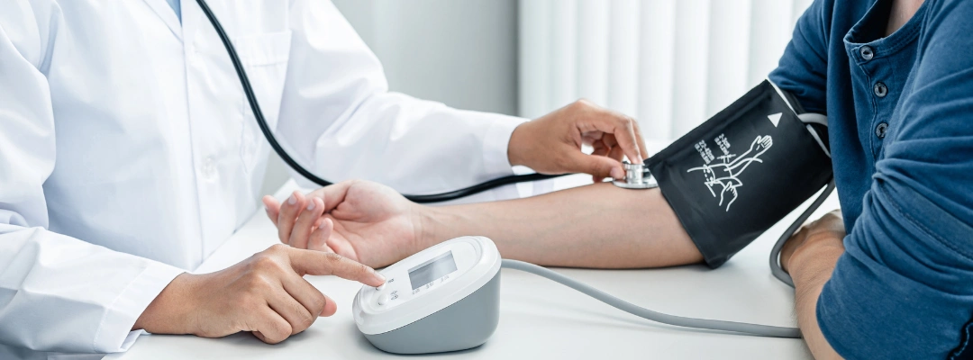 Image of a clinician reviewing blood pressure results with a patient while discussing hypertension during alcohol withdrawal