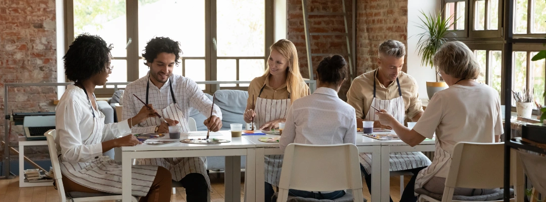 Therapy Projects for Addiction Treatment and Recovery – Purpose Healing Center Image of men and women wearing aprons sitting at a table working on art projects - Our 3 Art Therapy Projects for Addiction Treatment and Recovery - Purpose Healing Center